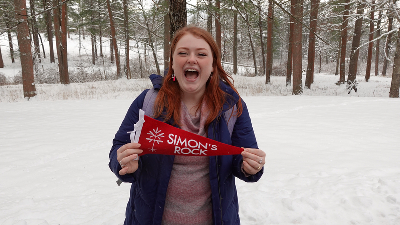 Student with Simon's Rock banner